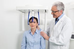 dentist taking CBCT scan of patient's mouth