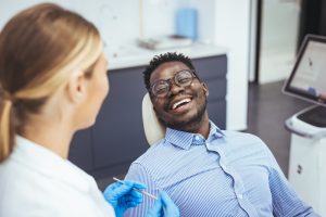 dental patient smiling speaking to dentist