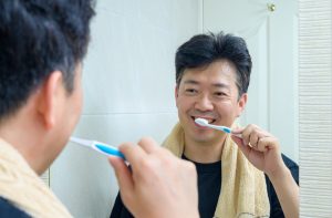 man brushing his teeth